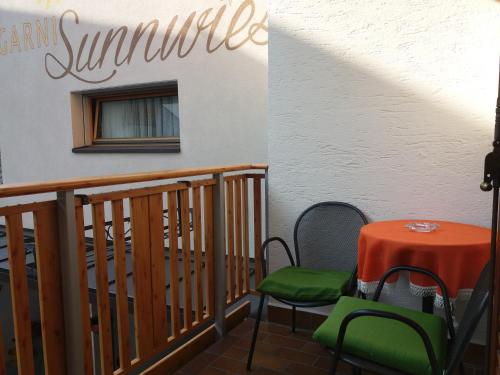 a table and chairs sitting on a balcony at B&B - Apartments Sunnwies in Marlengo