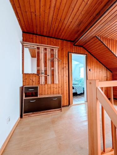 a living room with wooden walls and a wooden ceiling at Pension-Einfach Übernacht in Rüdesheim am Rhein in Rüdesheim am Rhein