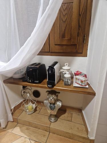 a kitchen with a shelf with a toaster and a microwave at Dimora Vasari in Arezzo