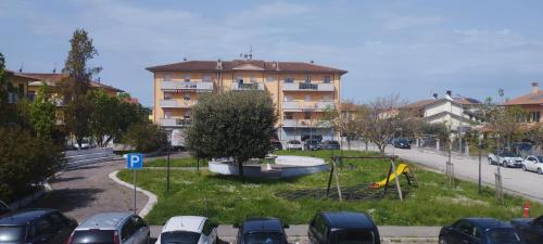 a parking lot with cars parked in front of a building at Casa Plac Appartamento Panoramico- Relax Garantito in Gatteo