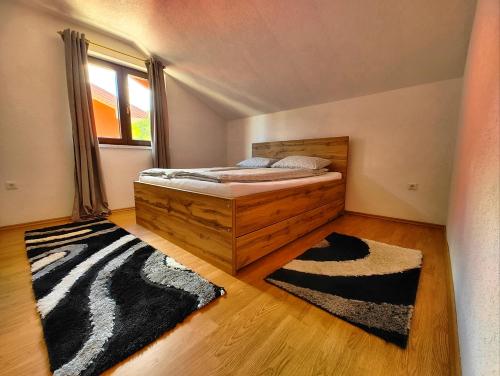 a bedroom with a bed and a window and a zebra rug at Apartment Residence House in Bihać