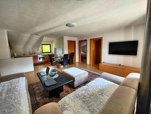 a living room with a couch and a table at Apartment Residence House in Bihać