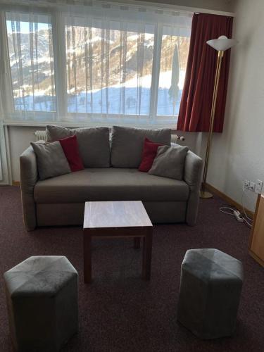 a living room with a couch and a coffee table at Haus Atlantic Leukerbad in Leukerbad