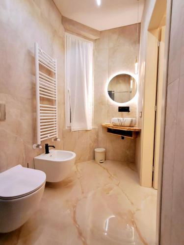 a bathroom with a white toilet and a sink at Frem lord in La Spezia