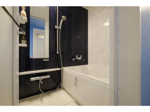 a bathroom with a shower and a sink and a tub at FourStoriesHotelMaihama Tokyo Bay - Vacation STAY 73118v in Tokyo