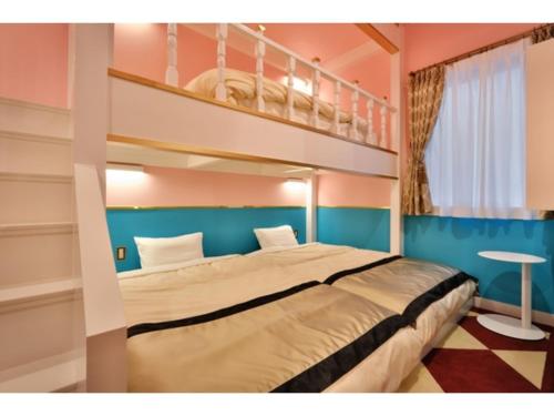a bedroom with a bunk bed and a staircase at FourStoriesHotelMaihama Tokyo Bay - Vacation STAY 73118v in Tokyo