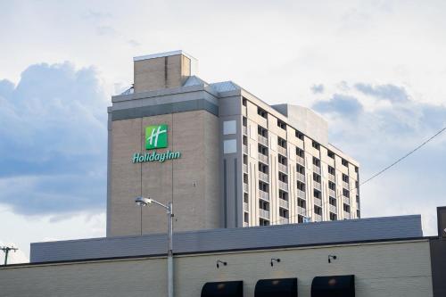 a building with a hilton sign on top of it at Holiday Inn Nashville - Vanderbilt - Dwtn by IHG in Nashville