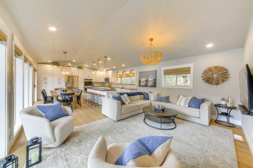 a living room with white couches and a kitchen at Peaceful Cabin with Dock on Lake Pend Oreille in Sagle