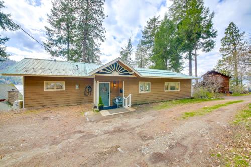 a small house with a dirt road in front of it at Peaceful Cabin with Dock on Lake Pend Oreille in Sagle