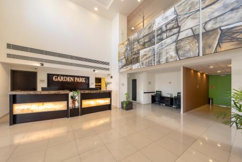 an office lobby with a large painting on the wall at Garden Park Hotel in San Luis Potosí