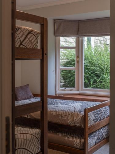 a bedroom with two bunk beds and a window at Bahía Coique in Futrono