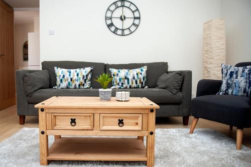 a living room with a couch and a coffee table at Fresh and spacious 3 bedroom home in Angus