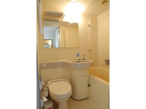 a bathroom with a toilet and a sink and a mirror at Smile Hotel Fukuoka Okawa - Vacation STAY 81535v in Ōkawa