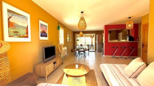 a living room with a couch and a tv at Villa Paradisu in Lumio