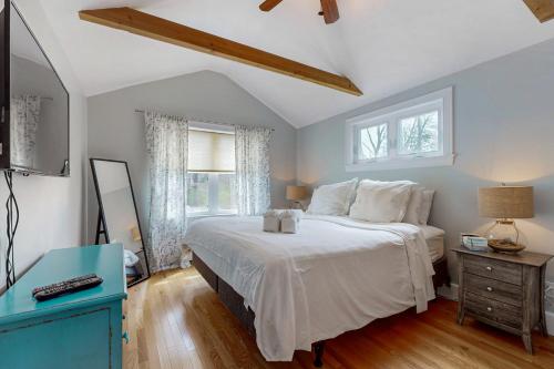 a bedroom with a large bed and a blue table at Namskaket Retreat in Orleans