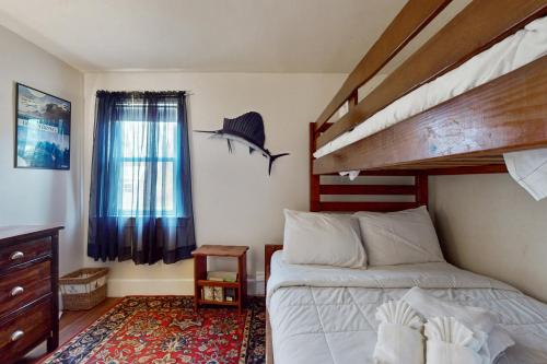 a bedroom with a bed and a bunk bed at Namskaket Retreat in Orleans