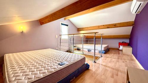 a bedroom with a bed and a purple wall at Villa Paradisu in Lumio