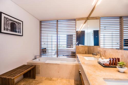 a large bathroom with a tub and a sink at Dreams Karibana Cartagena Golf & Spa Resort in Cartagena de Indias