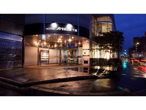 a building on a city street at night at Hotel AreaOne Chitose - Vacation STAY 99764v in Chitose