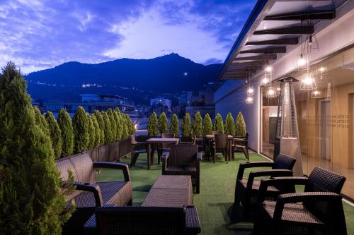 a patio with tables and chairs on a balcony at Novotel Bogota Parque 93 in Bogotá