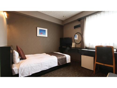 a hotel room with a bed and a desk at Hotel AreaOne Chitose - Vacation STAY 99089v in Chitose