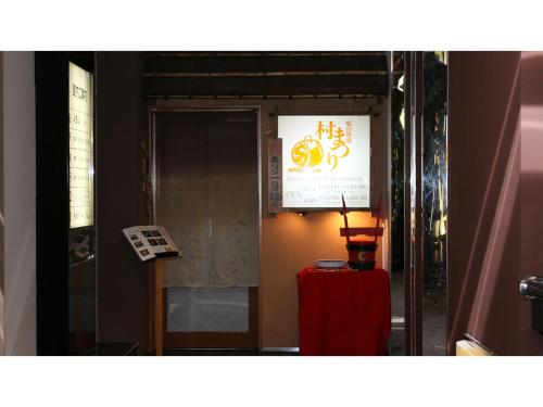 a door with a sign and a red suitcase at Hotel AreaOne Chitose - Vacation STAY 99100v in Chitose