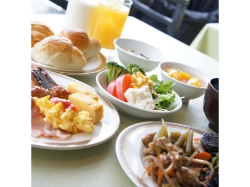 a table topped with plates of food and drinks at Hotel AreaOne Chitose - Vacation STAY 99775v in Chitose