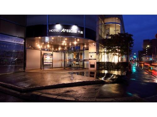 a building on a city street at night at Hotel AreaOne Chitose - Vacation STAY 99775v in Chitose