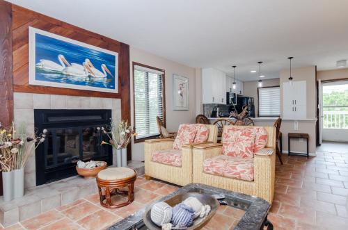 a living room with a couch and a fireplace at Waves N At by Bryant Real Estate in Kure Beach