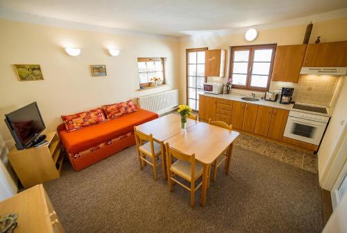 a living room with a table and a couch at Pension Jana in Český Krumlov
