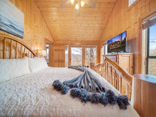 a bedroom with a bed in a wooden cabin at Edens View in Gatlinburg