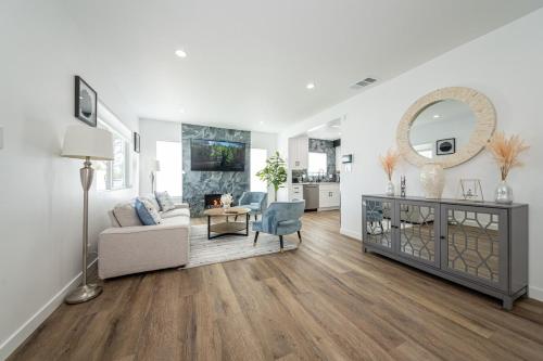 a living room with a couch and a mirror at Gated Private Home next to Universal Studios in Van Nuys County Court Heliport