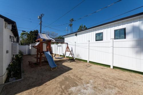 a playground in front of a white building at Gated Private Home next to Universal Studios in Van Nuys County Court Heliport