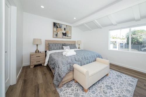 a bedroom with a bed and a chair and a window at Gated Private Home next to Universal Studios in Van Nuys County Court Heliport
