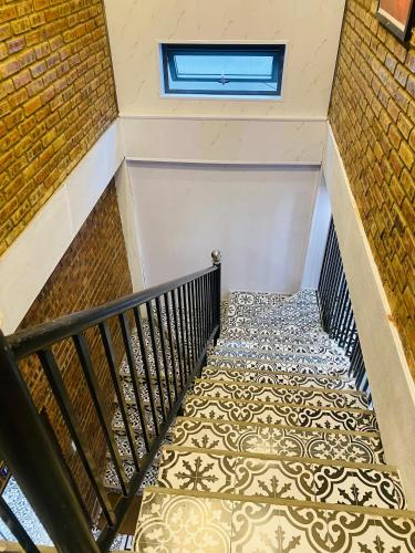 a staircase with a tile floor and a window at Sunshine villa thuan an in Hue