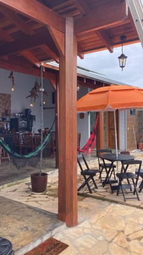 an outdoor patio with a hammock and an umbrella at Recanto do sossego in Sinop