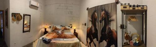 a bedroom with a bed with a painting on the wall at Recanto do sossego in Sinop