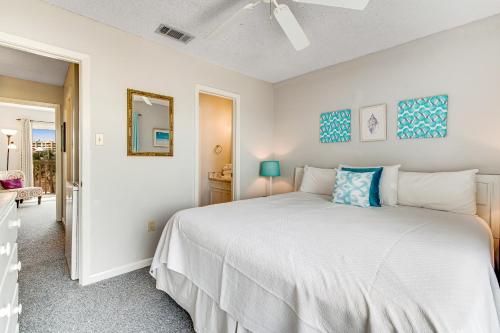 a bedroom with a white bed and a mirror at Fort Morgan Townhomes E7 in Fort Morgan