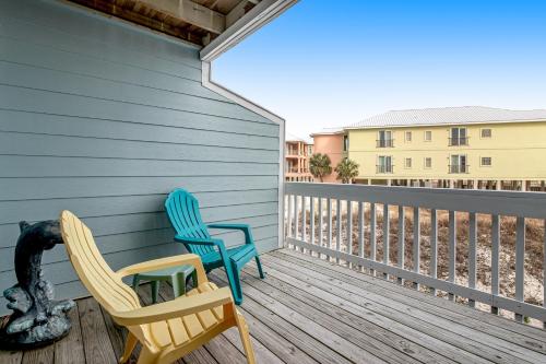 two chairs on the porch of a house at Fort Morgan Townhomes E7 in Fort Morgan