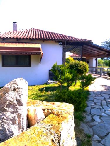a stone wall in front of a house at Oasis Cottage in Krepeni