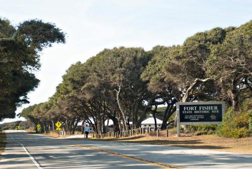 a road with a sign on the side of it at Rudicile by Bryant Real Estate in Kure Beach