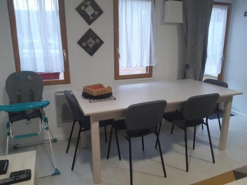 a dining room table and chairs in a room at Cosy Little Cottage in Landepéreuse