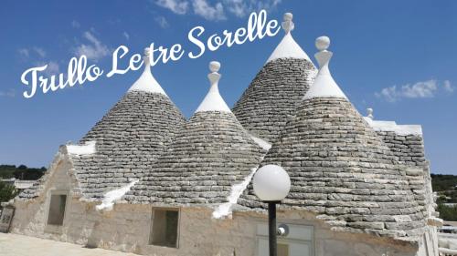 a building with a roof with the words little lego league scania at Trullo Le Tre Sorelle in Cisternino