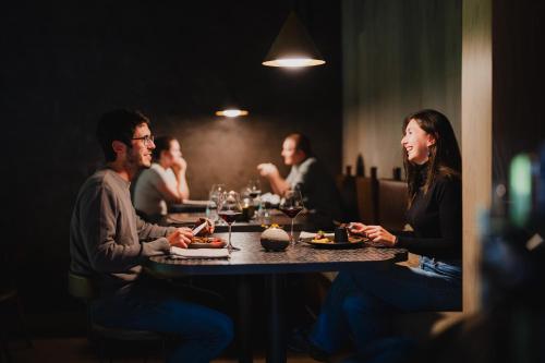 a group of people sitting at a table in a restaurant at Milford Sound Lodge in Milford Sound