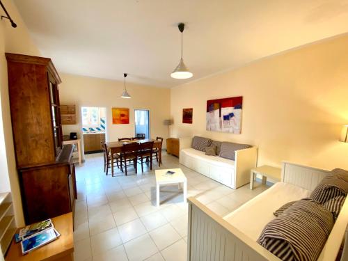 a living room with a couch and a table at Belvedere Residenza Mediterranea in Portoferraio