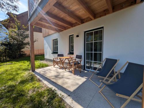 a patio with a table and chairs on a patio at Haus Christl&Franz in Bad Aussee