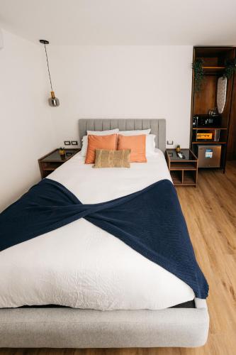 a bedroom with a large bed with orange pillows at Casa Castillo Condesa in Mexico City