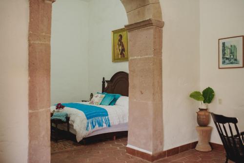 Una cama o camas en una habitación de Hacienda de Comodejé