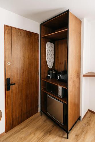 a kitchen with a wooden cabinet and a door at Casa Castillo Condesa in Mexico City