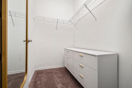 a room with a white dresser and a closet at Beautiful Home, Walk to UF, Newly built in Gainesville